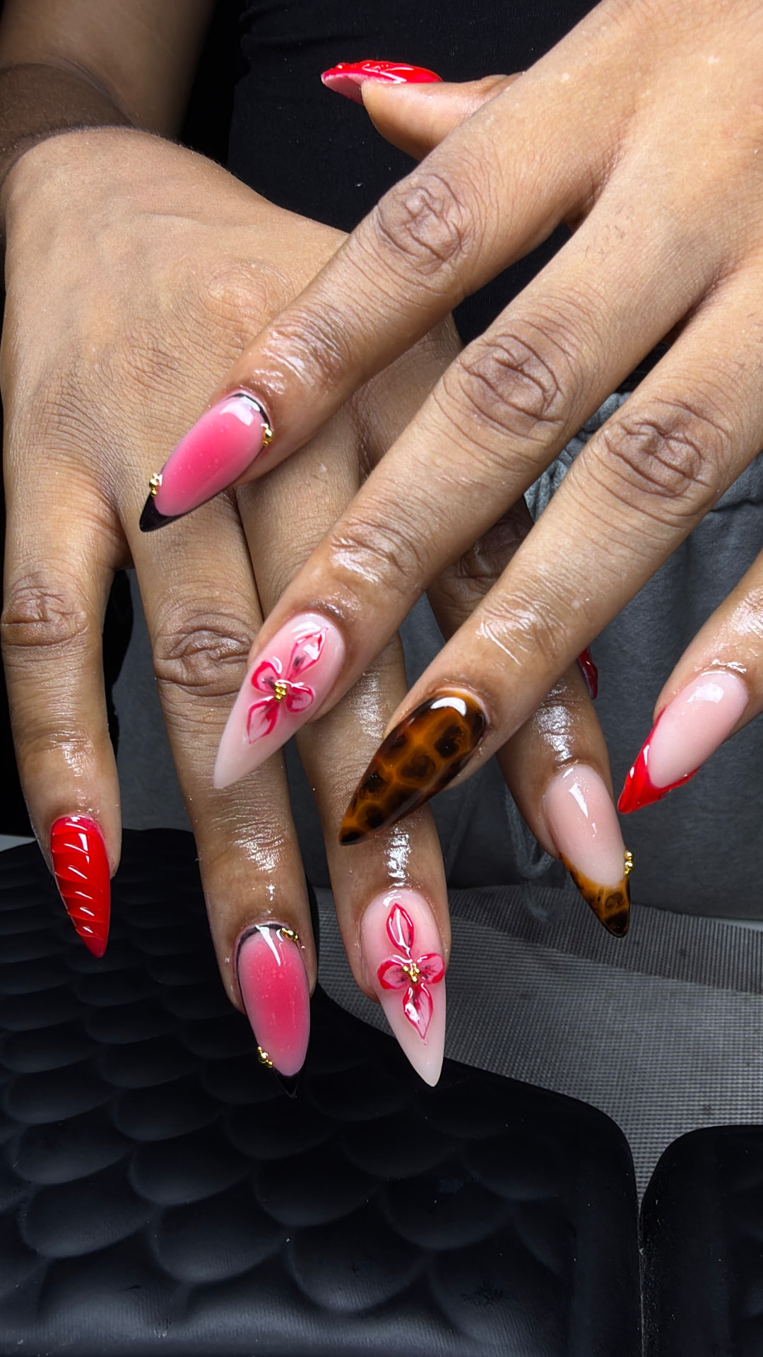 Stiletto nails with 3D pink florals and red tips
